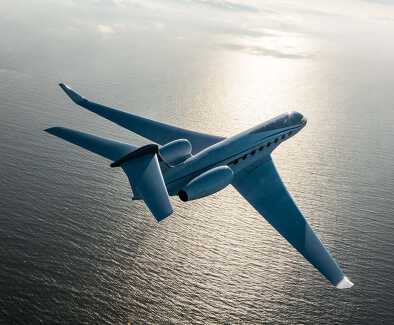 Gulfstream G550 in flight over ocean Gulfstream G550 in flight over ocean