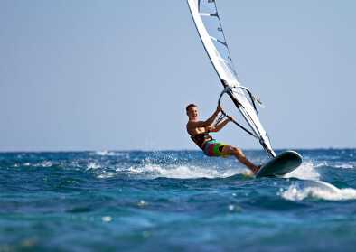 Young man surfing the wind on a bright summer day
Young man surfing the wind on a bright summer day