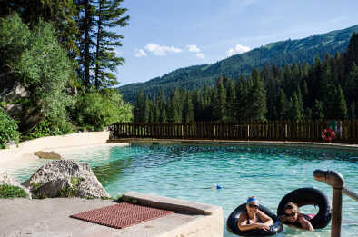 Deux amies profitent des sources chaudes de Granite Creek à Jackson Wyoming avec des chambres à air noires. Deux amies profitent des sources chaudes de Granite Creek à Jackson Wyoming avec des chambres à air noires.