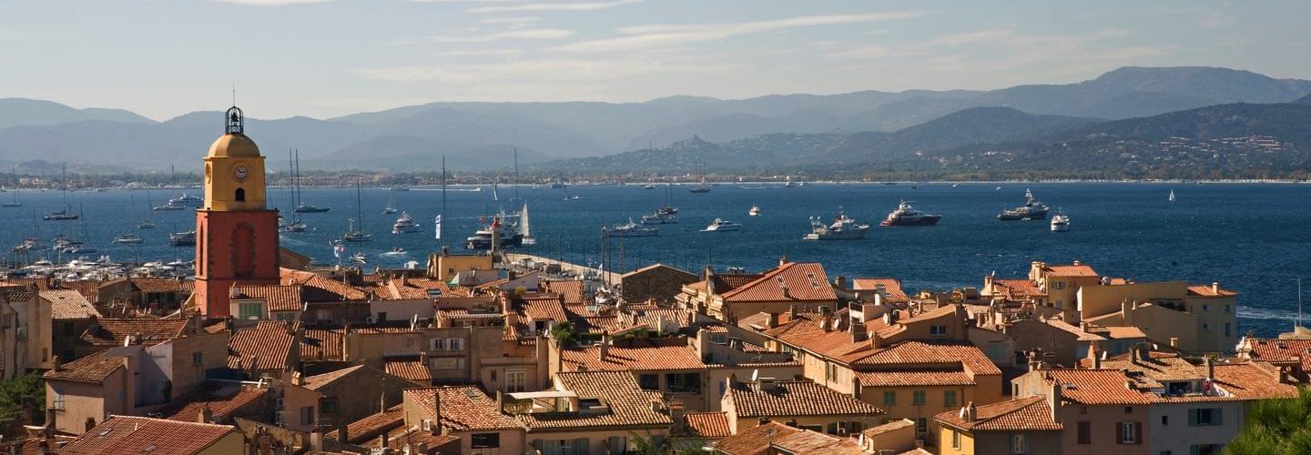 View of red tiles rooftops and Clocher de Saint Tropez and yachts on the Mediterranean sea