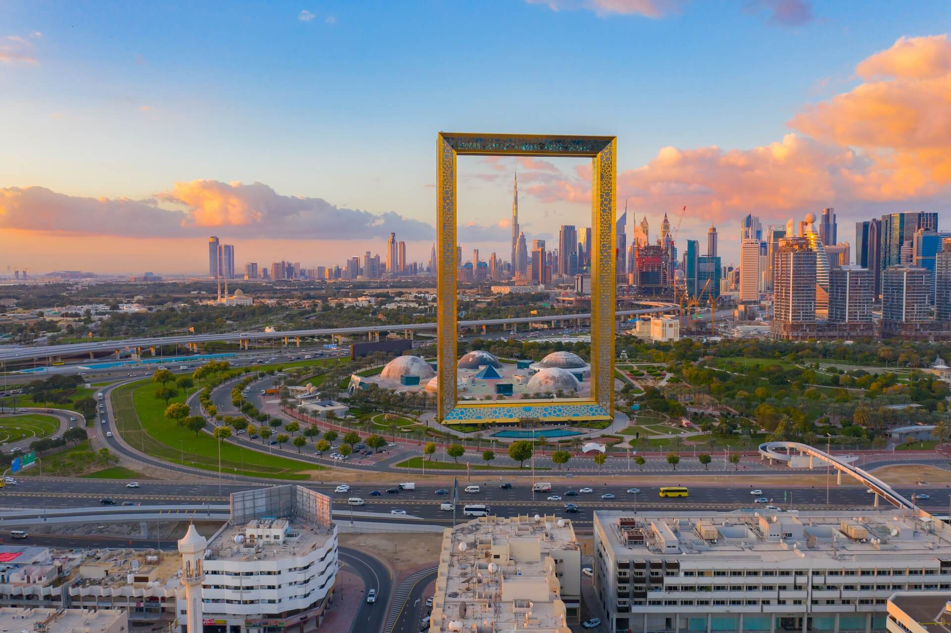 Aerial view of Dubai Frame, Downtown skyline, United Arab Emirates or UAE. Financial district and business area in smart urban city. Skyscraper and high-rise buildings at sunset.

