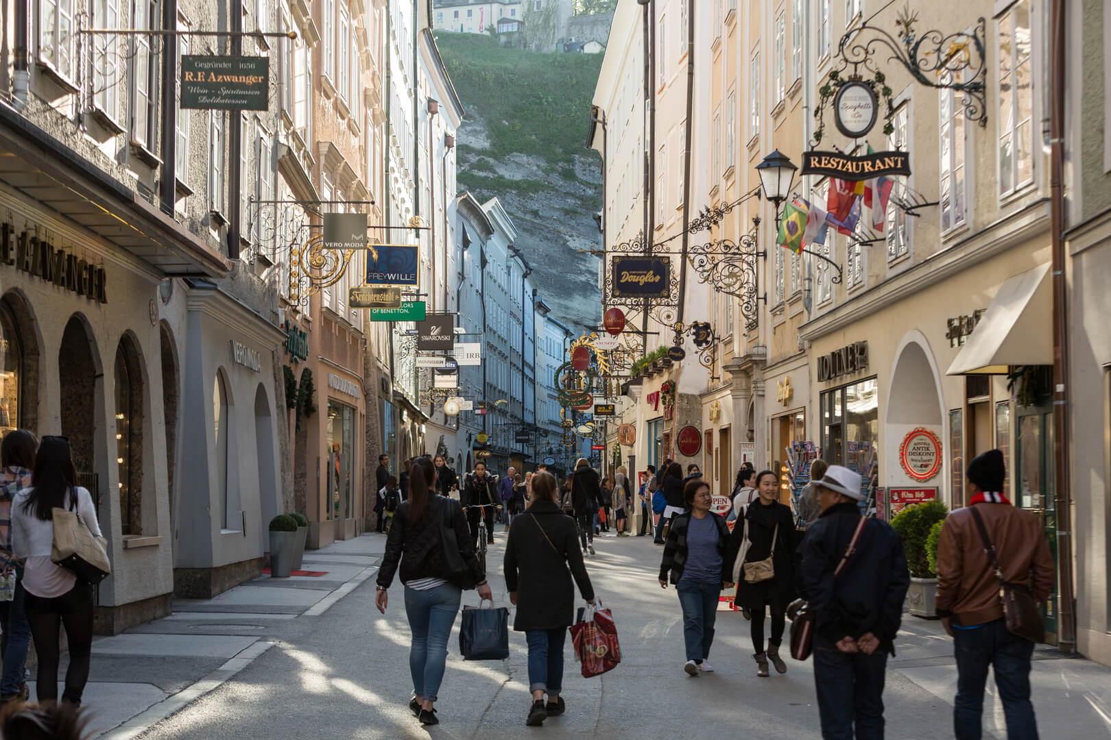 Unidentified People Walking at Famous Historical Shopping Street Getreidegasse in Salzburg. Getreidegasse, is one of the oldest streets in Salzburg