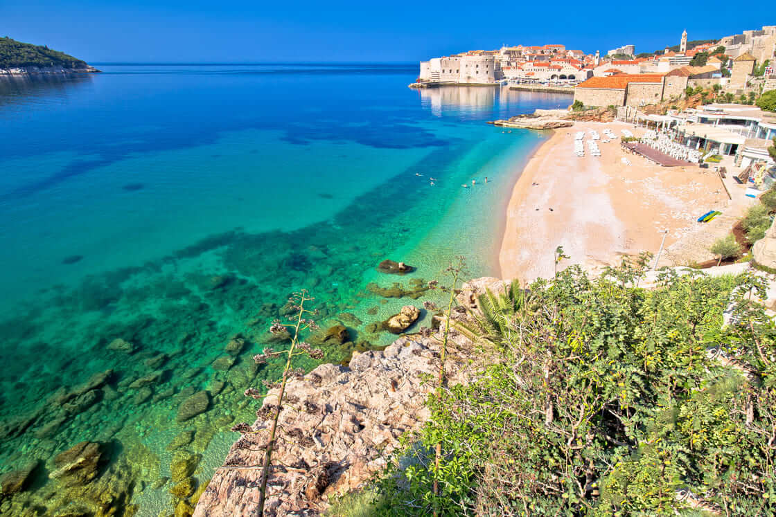 Dubrovnik. Banje beach and historic walls of Dubrovnik view, famous destination in Dalmatia region of Croatia
