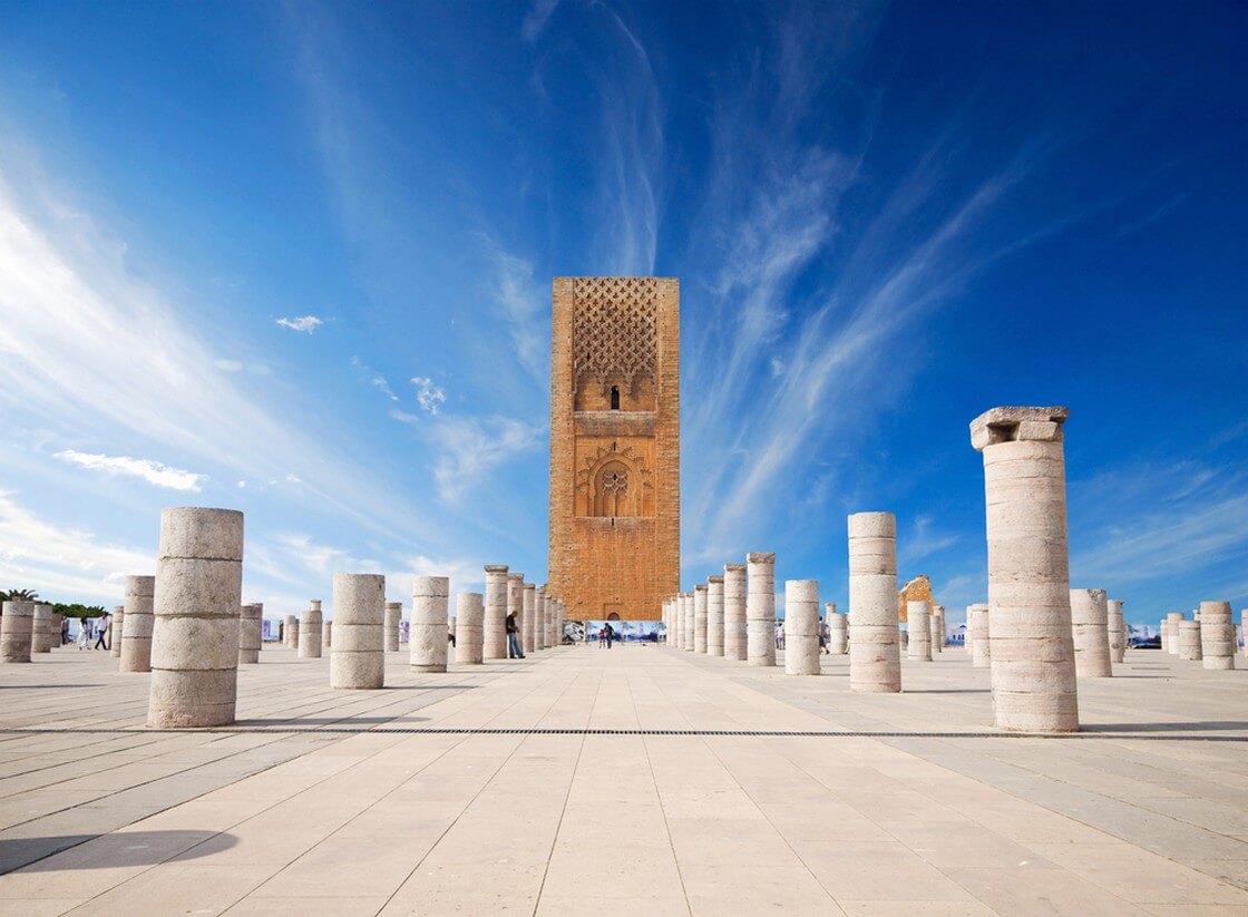 Tour Hassan tower in the square with stone columns. Made of red sandstone, important historical and tourist complex in Rabat, Morocco. Instead of stairs, the tower is ascended by ramps