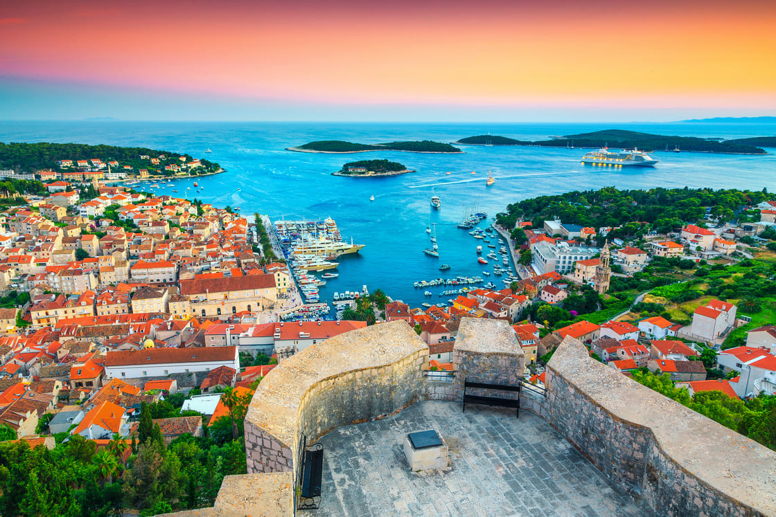 Famous touristic and travel destination. View from the Tvrdava Fortica (Spanjola) fortress at sunset. Green islands, blue lagoons and fantastic harbor, Hvar, Hvar island, Dalmatia, Croatia, Europe