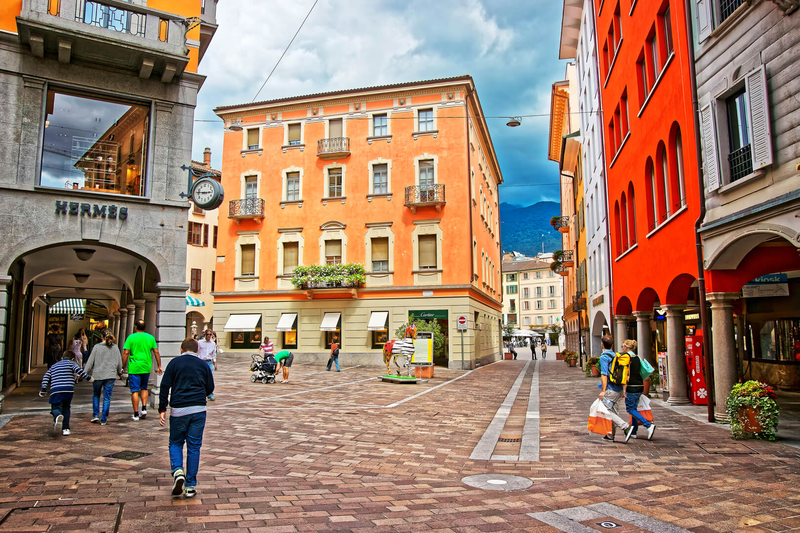 Via Nassa Street in the city center of luxurious resort Lugano, Ticino canton of Switzerland. People on the background.