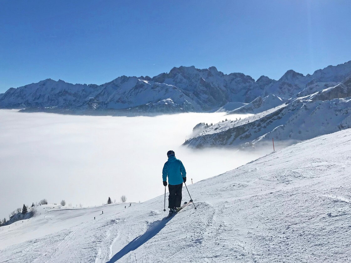Ski slope in Garmisch Partenkirchen over misty valley
