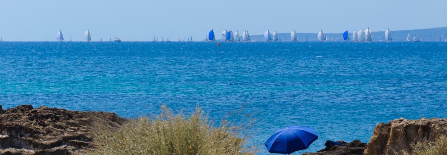 Blue sunshade with the copa del rey regatta in the background in Mallorca Spain