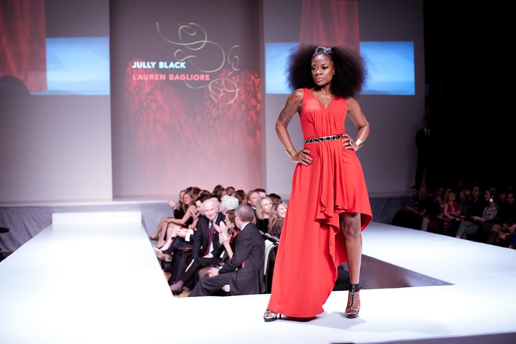 Black top model with a red dress on the catwalk at the London Fashion Week 2014