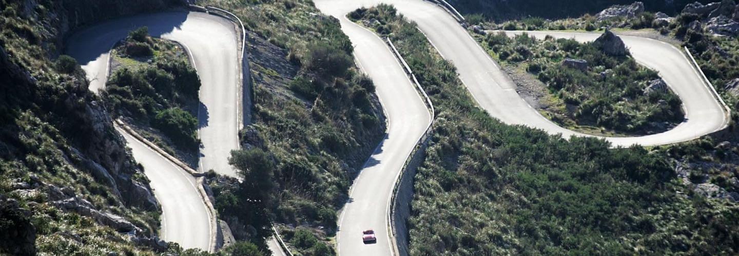 Porsche classical sports car on a sinous mountain road at the Rally Clásico Isla Mallorca