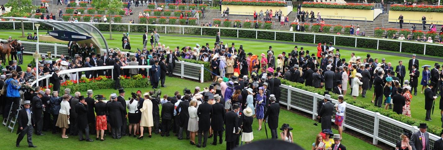 Well dressed wealthy people waiting to admire one of the horses at the Royal Ascot London