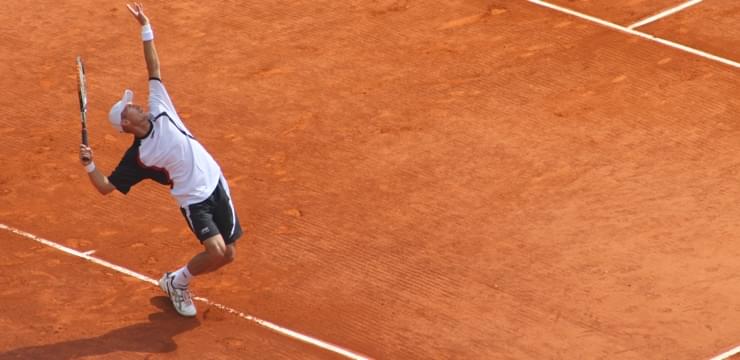 Tennis player serving at the Rolex Masters in Monte Carlo