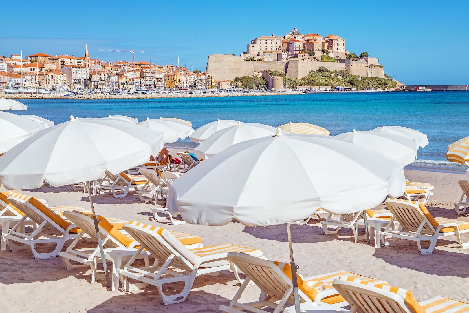 Parasols on the sandy beach of Calvi in Corsica
