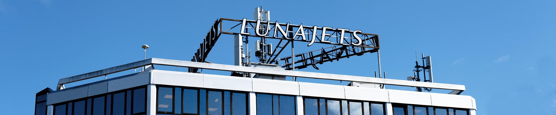 LunaJets headquarters with the sign of the company's logo on the roof by daylight