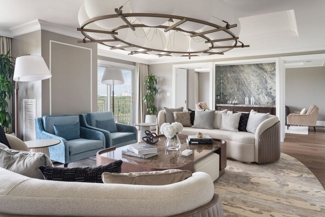 Lounge mit mehreren Besprechungsbereichen, großen Fenstern, Sofas und Tischen unter den Kronleuchtern des Ritz Carlton.