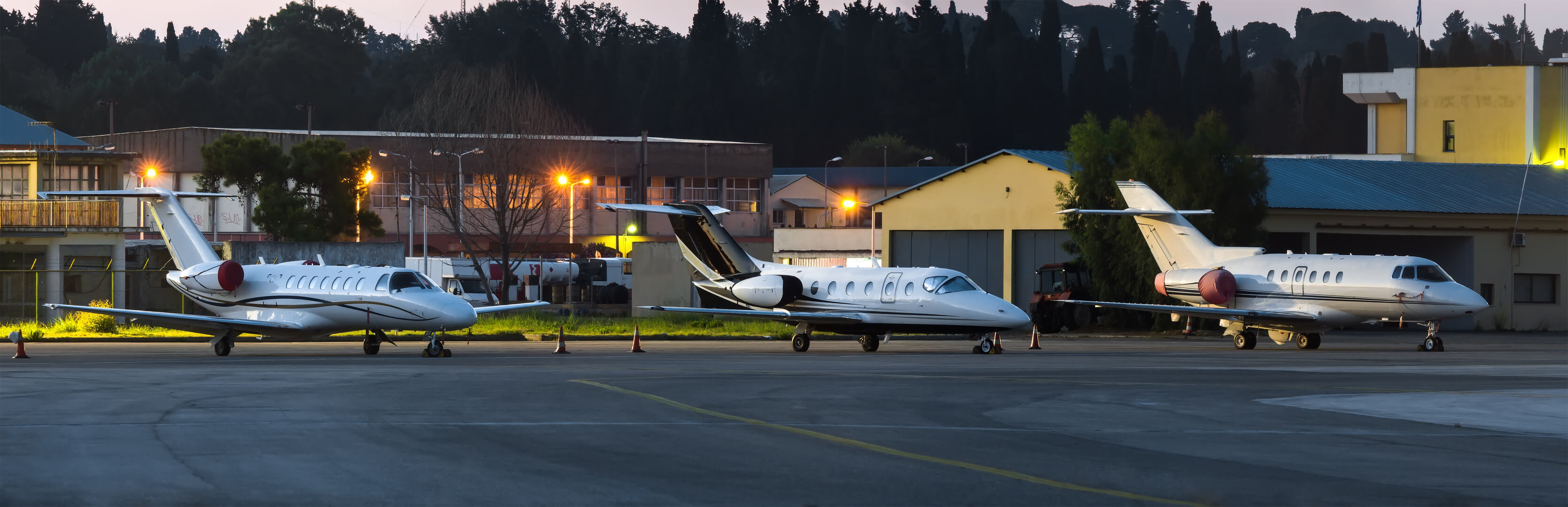 Panoramic view at night on private business planes, on a parking space