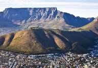 Aerial view of cape town in Africa with a hill in the center and a mountain in the background