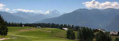 Golf course in the middle of the mountains at Crans Montana in Switzerland