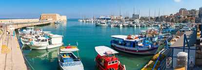 Photo of the port of Iraklion in Greece where many boats are moored.