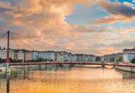 Passerelle du Palais de Justice red bridge on the Saône river in Lyon during sunset