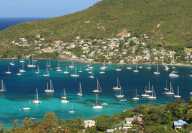 Aerial view of a bay on Mosquito Island in the Caribbean with many moored pleasure boats