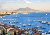 Naples port in summer with boats and the Mediterranean sea and mount vesuvius in the background
