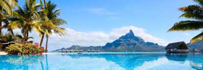 View of a beach in Tahiti with its turquoise water and volcano in background