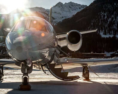 Parked at Samedan Engadin Airport above a snow park on the last day of the day. Private bizjet plane used by business people, VIPs and wealthy people to travel around the world.