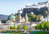 Sonniger Blick von der Salzach auf die Burg Hohensalzburg und den Salzburger Dom im Sommer