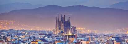 Basilica and Expiatory church Sagrada Familia of Antoni Gaudi in Barcelona and city-center by night