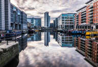 Leeds, West Yorkshire, England, Britain, December 2016, modern architecture with apartments and offices using long exposure showing cloud movement at Leeds Dock
