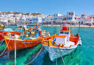 Harbour with wooden fishing boats in Chora town on sunny summer day, Mykonos island, Greece -- Greek landscape
