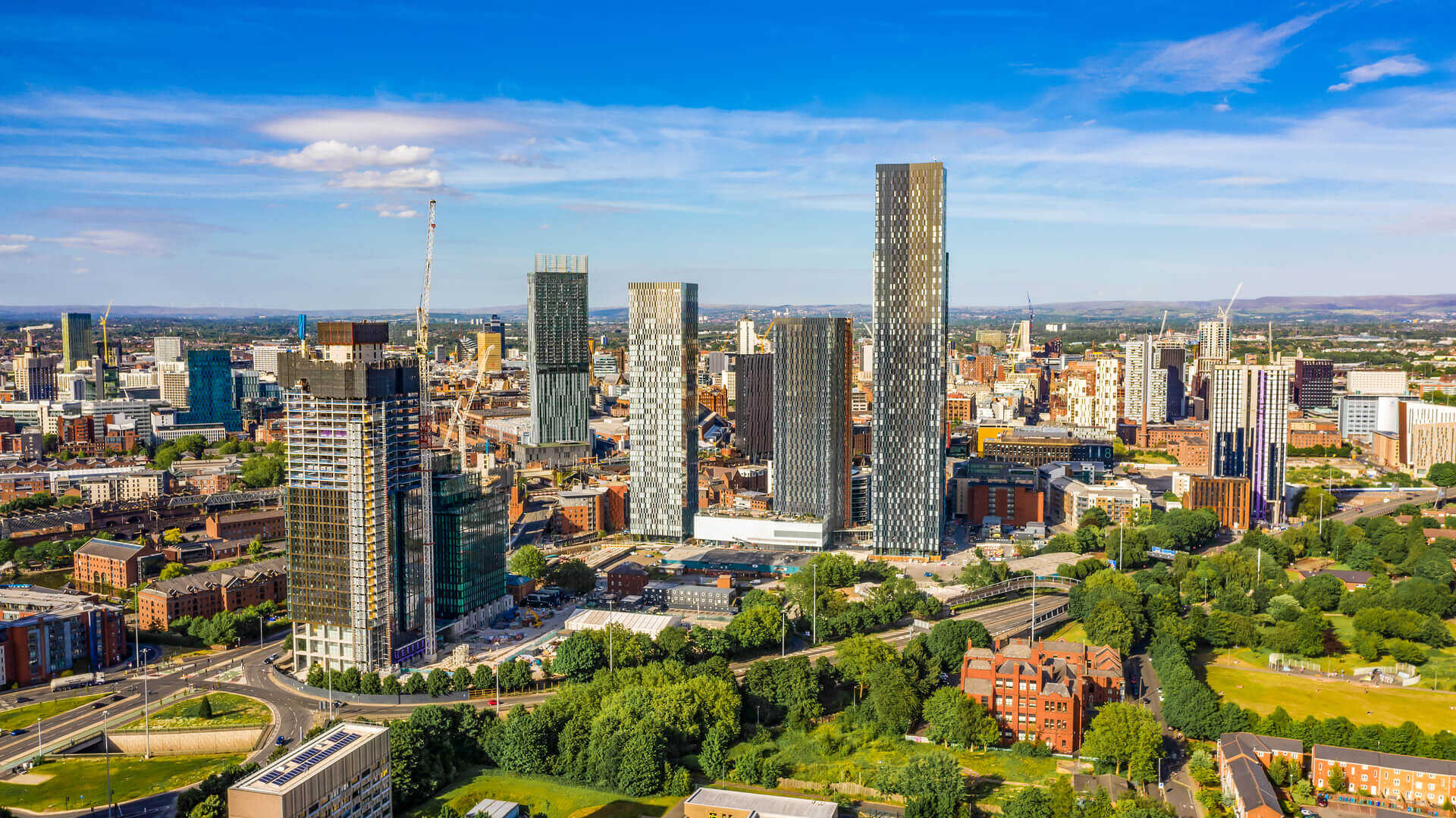 Aerial shot of Manchester UK on a beautiful summer day during pandemic lock-down
