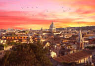 View of Rome with the colosseum on the left with sunset in the background