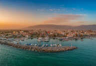 Idyllic landscape flying above Kalamata's Marina at sunset. Aerial photography of Kalamata city, Messenia, Peloponnese, Greec