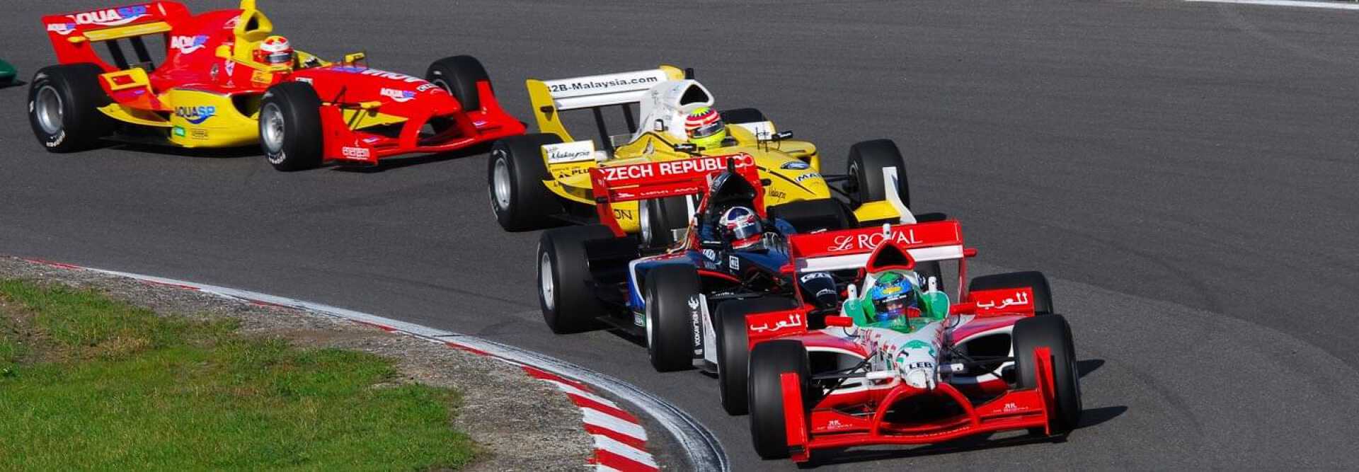 Four racing cars coloured in red and yellow at the Austrian Grand Prix Spielberg