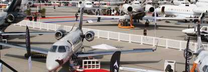Several private jet models on red carpet at the EBACE, the European Business Aviation event