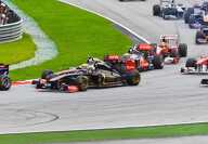 Seventeen formula one racing cars in a turn at the Hungarian F1 grand prix in Budapest