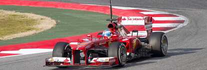 Red Ferrari formula one racing car during the Italian F1 Grand Prix in sunlight