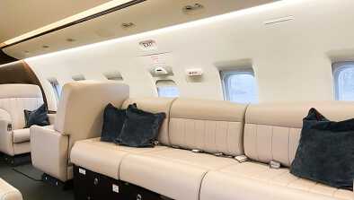 Large couch in the Bombardier Challenger 604 cabin