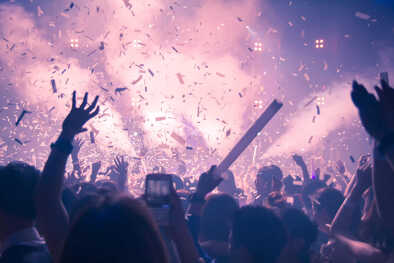 Abstract Background Party Concert Concept. Party people concept. Crowd happy and joyful in club. Celebration, festival, Happiness, Blurry night club .Event Show concert EDM on stage.