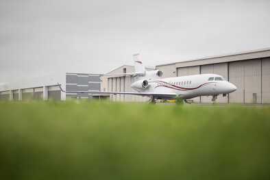 A Falcon 7X parked next to the aircraft hangar A Falcon 7X parked next to the aircraft hangar