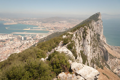 The Rock of Gibraltar is a monolithic limestone promontory located in the British overseas territory of Gibraltar, 