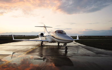 Honda jet parked on wet tarmac at airport