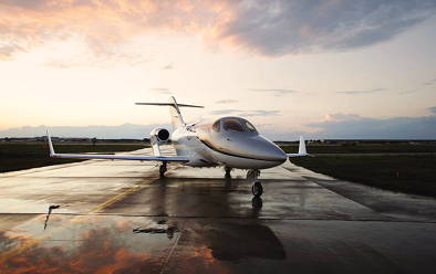 Honda jet parked on wet tarmac at airport Honda jet parked on wet tarmac at airport