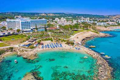 Cyprus. Panorama with drone. Protaras. Paralimni. Nissia Lombardi Beach bird's eye view panorama. Blue Bay. Small bay with coast protrusions in the sea. Mediterranean sea. Beach resorts of Cyprus.
