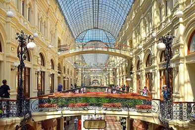 Interior of GUM (main store) on Red Square, Russia. GUM is one of the oldest supermarkets in Moscow and a tourist attraction. Luxury interior with a beautiful fountain inside the mall.