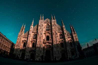 View of the Cathedral of Milan at night with stars in the sky View of the Cathedral of Milan at night with stars in the sky