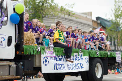 parade of a young soccer team driving by parade of a young soccer team driving by
