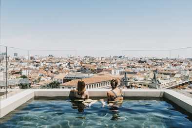 two girls in the swimming pool which provides outstanding views of Madrid